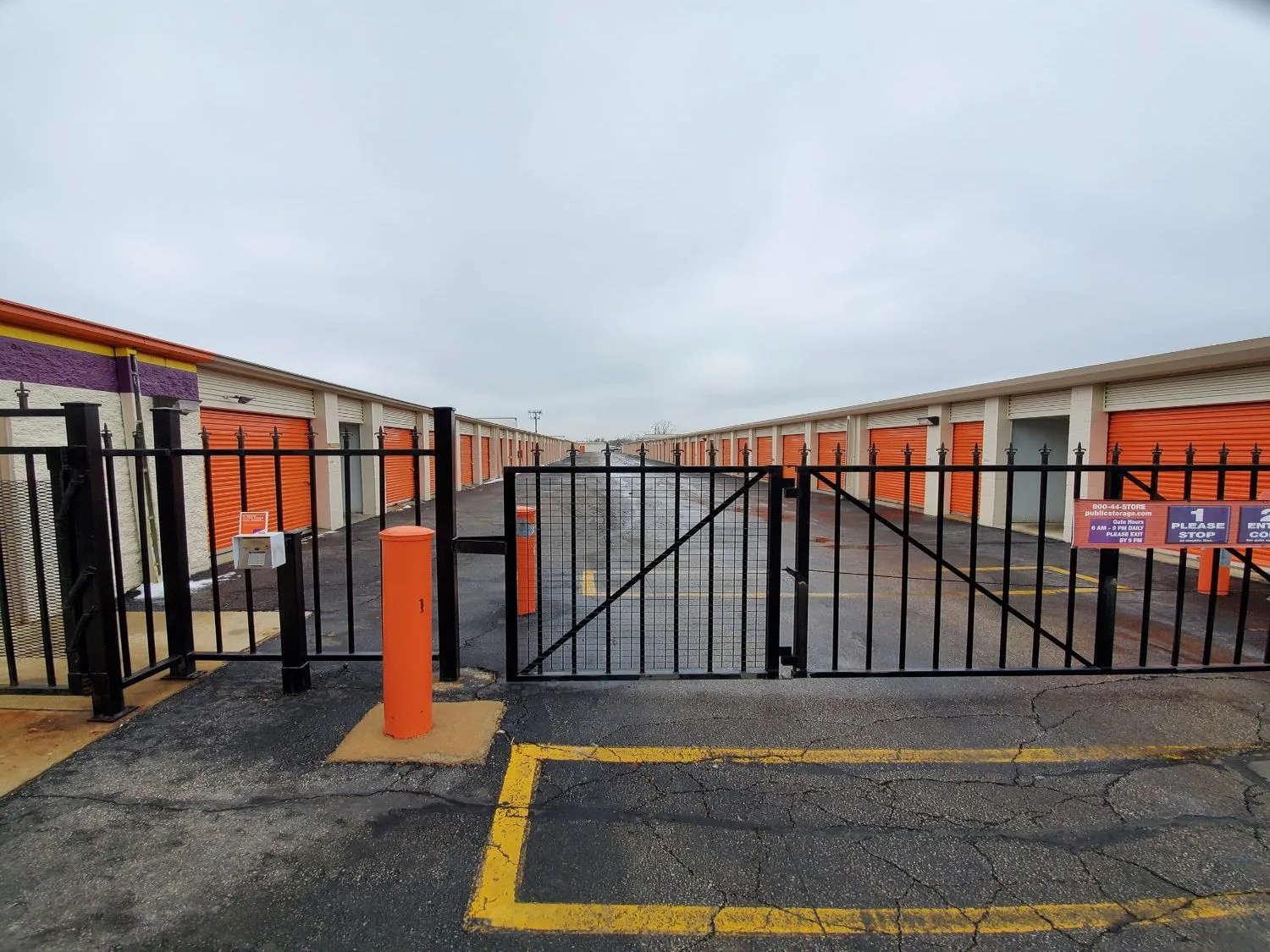 Automatic black steel gate at the entrance of a self-storage facility